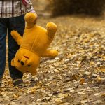 child walking, kicking leaves