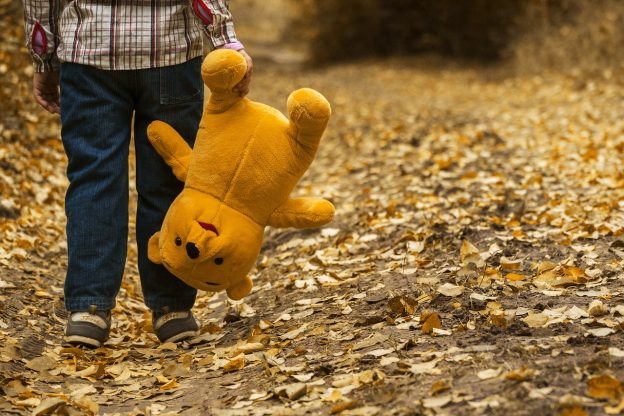 child walking, kicking leaves