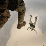 sky divers falling through the clouds