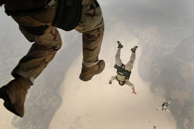 sky divers falling through the clouds