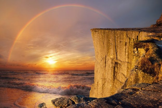 Rainbow over the ocean waves photo